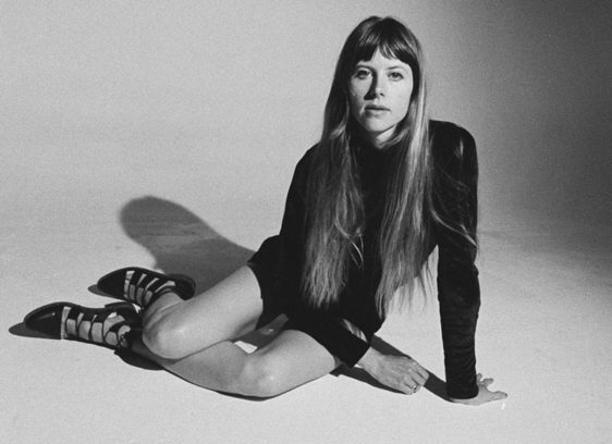 Things to do in Santa Cruz black and white studio shot of Lael Neale sitting on a bare floor