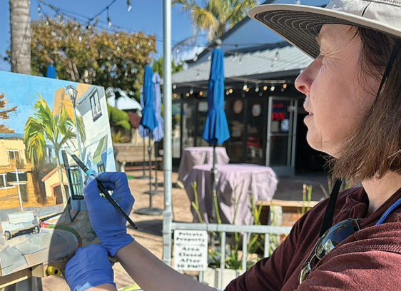 Capitola Plein Air Continues Through Nov. 9 woman painting a landscape on canvas outdoors