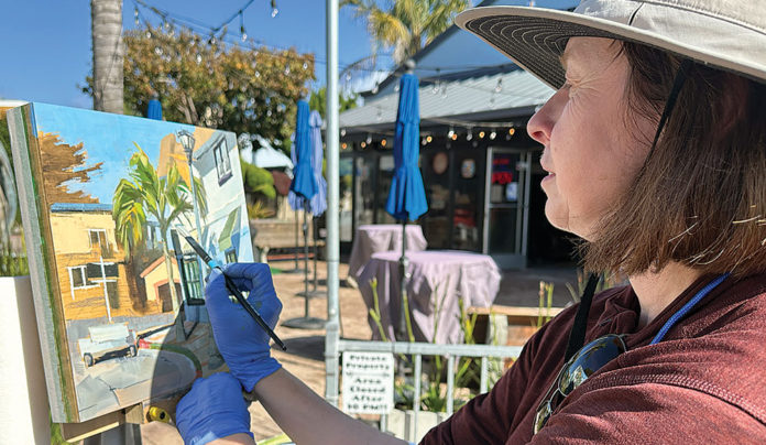 Capitola Plein Air Continues Through Nov. 9 woman painting a landscape on canvas outdoors