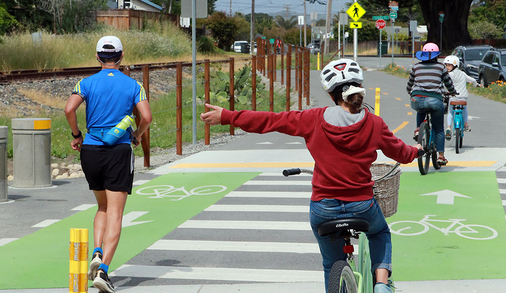 A bicyclist and a jogger on what might become the Rail Trail