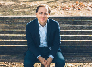 DROWNING? NOPE David Litt seated in a casual blue suit