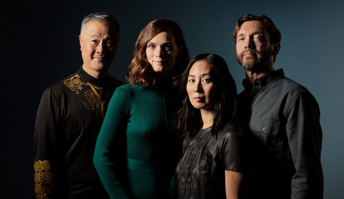 East Greets West Members of the Del Sol Quartet pose together against a dark blue background.
