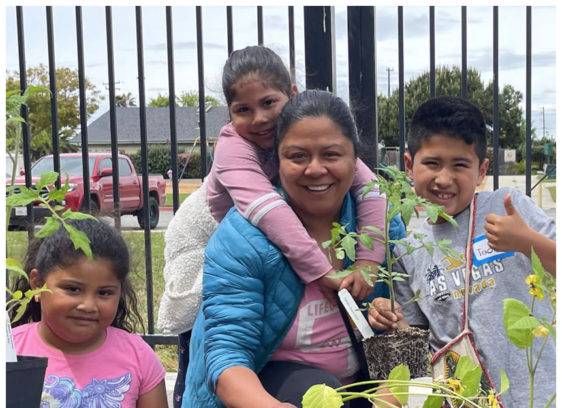 The Editor’s Desk A smiling woman and three children plant vegetables together in portable grow bags during a Monterey Bay Master Gardeners workshop.