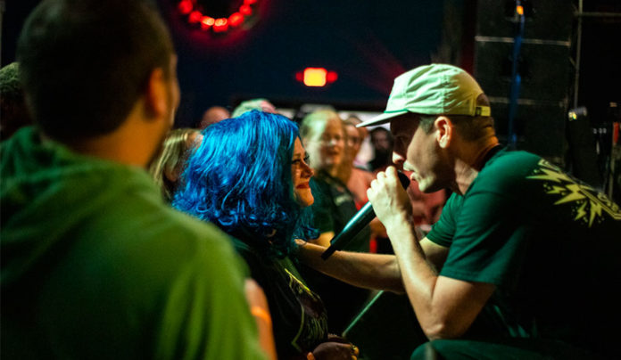 Things to do in Santa Cruz Emcee Wax performs up close with fans during a live show.