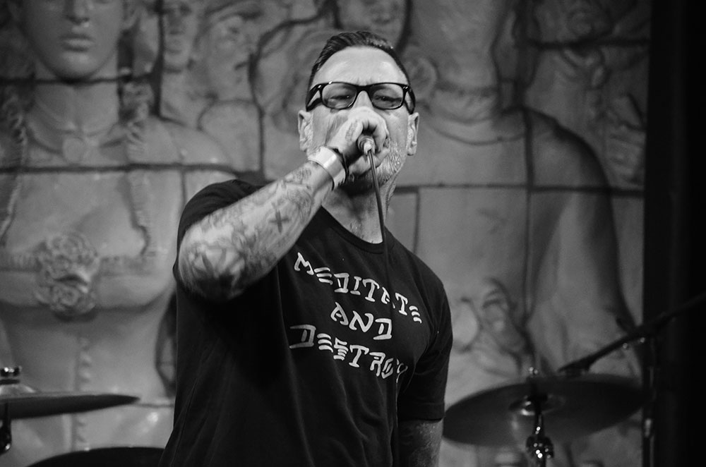 Man singing into a microphone onstage