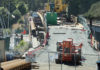 Bridge Still Out Construction equipment and materials sit atop the closed Murray Street Bridge in Santa Cruz, with fencing and warning signs blocking access.