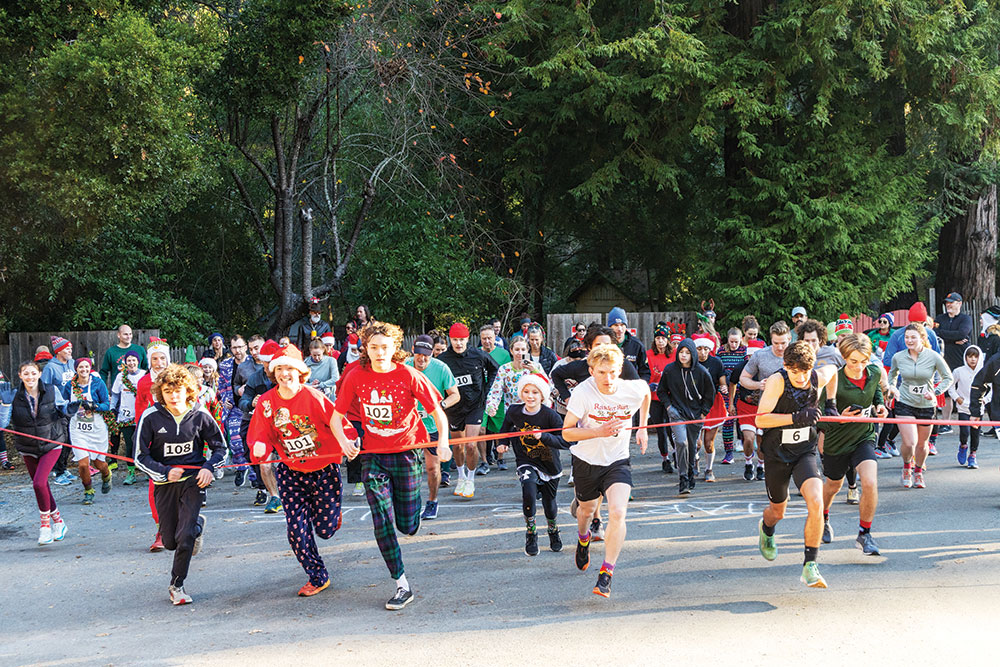 Runners in holiday attire burst through the starting line at the annual Reindeer Run in Santa Cruz.