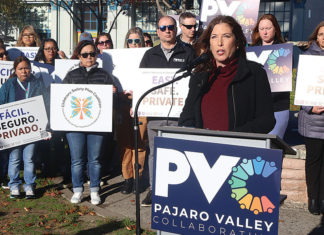 Local Group Urges Adoption of Childcare Safety Plan People at a rally holding signs