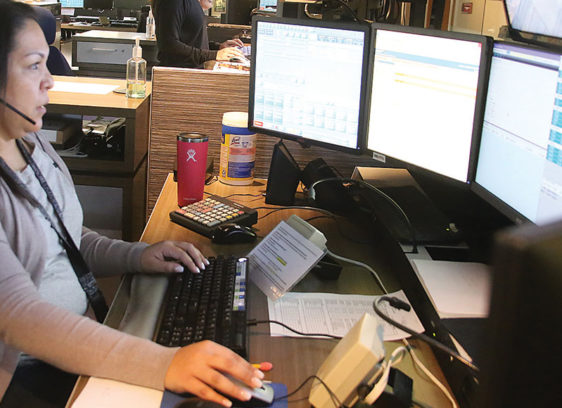 Santa Cruz County, Cities Signal Support for Encrypted Radio System Woman sitting in front of multiple computer screens