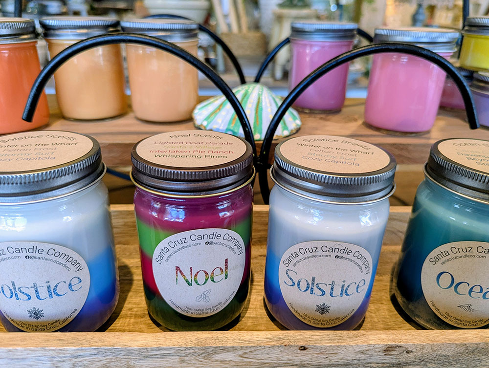 Candles in jars arranged on a wooden display