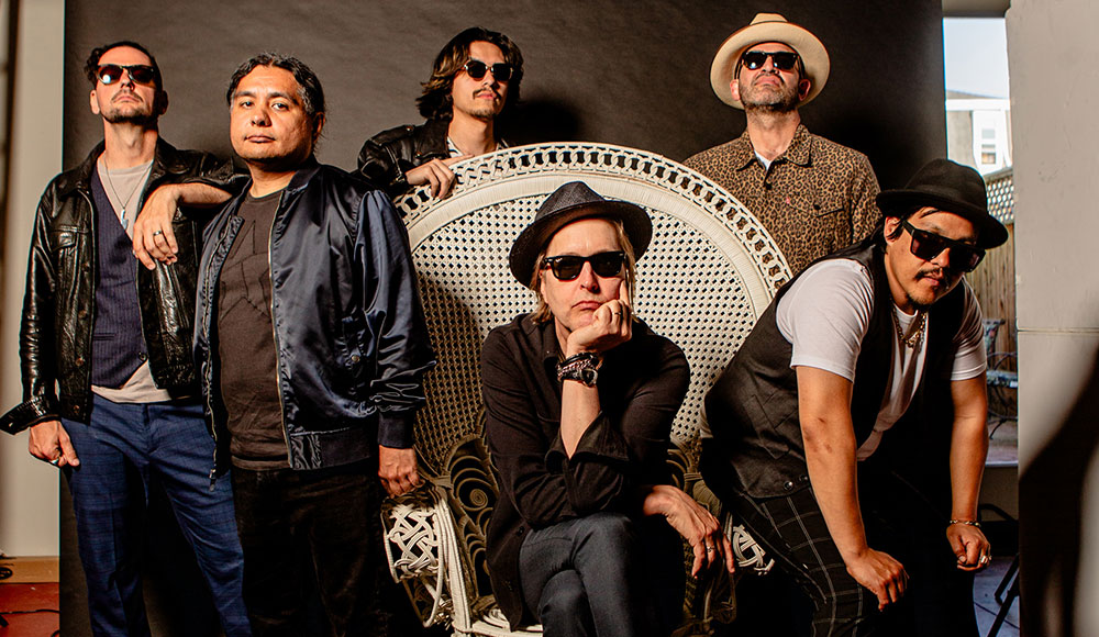 Chuck Prophet poses with members of Salinas-based band ¿Qiensave? during a promotional photo shoot.