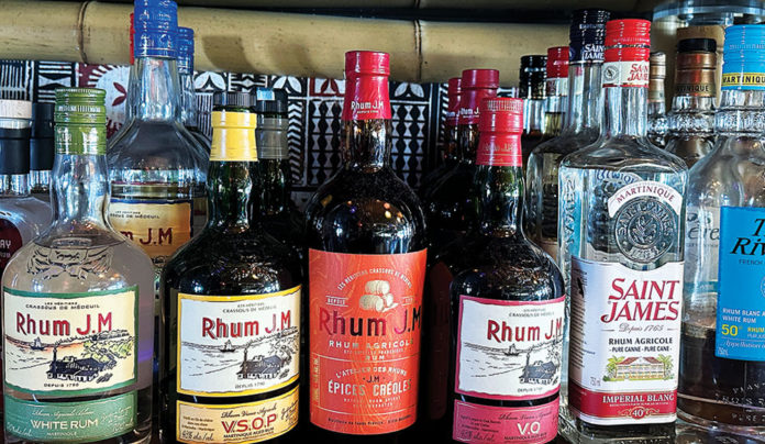 The Editor’s Desk Bottles of rum from around the world displayed on shelves at a Santa Cruz Wharf restaurant bar.
