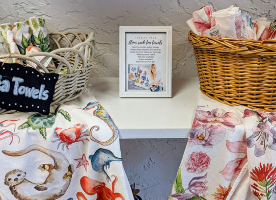 Holiday Gifts: Last-Minute and Local Display of tea towels arranged in straw baskets