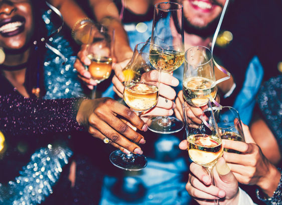 Last Night’s Best People clink champagne glasses during a festive New Year’s Eve celebration.