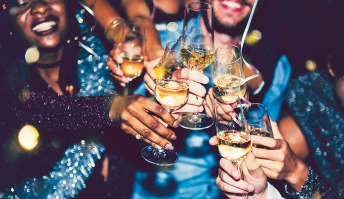 Last Nightโs Best People clink champagne glasses during a festive New Yearโs Eve celebration.
