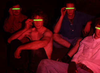 Painting the Town Members of the Santa Cruz band Red 40 pose under red lighting while holding glowing green strips over their eyes.