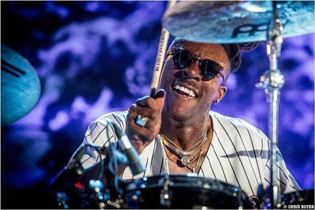Jazz drummer Blaque Dynamite performing live on stage behind a drum kit