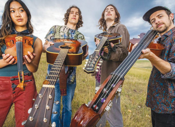Red-Hot and Blue 810 Four musicians stand outdoors holding string instruments including a fiddle, guitars, and a bass.