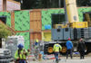 Affordable housing project back on track Construction workers and a crane at a modular housing project under construction.