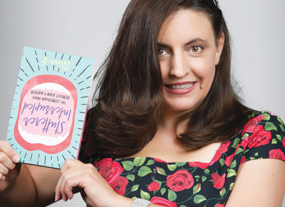 Camera. Lights. Ssss Comedian Nina G holds a copy of her memoir while posing for a portrait.