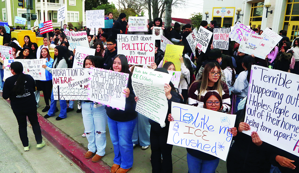 Students hold handmade signs during a walkout protest outside Watsonville High School.