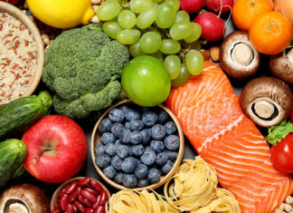 Flipping the Food Pyramid Fresh fruits, vegetables, grains, legumes, and salmon arranged on a table.