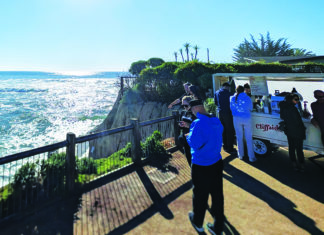 For Shore Customers gather at Cliffside Coffee cart overlooking the Pacific Ocean at Pleasure Point