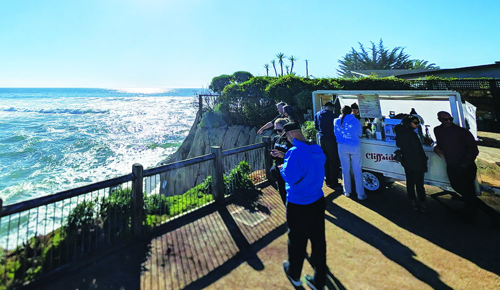 Customers gather at Cliffside Coffee cart overlooking the Pacific Ocean at Pleasure Point