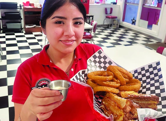 Arrive and Thrive Sherlyn Alvarez serves the Monte Carlo sandwich with onion rings at Brookdale Diner