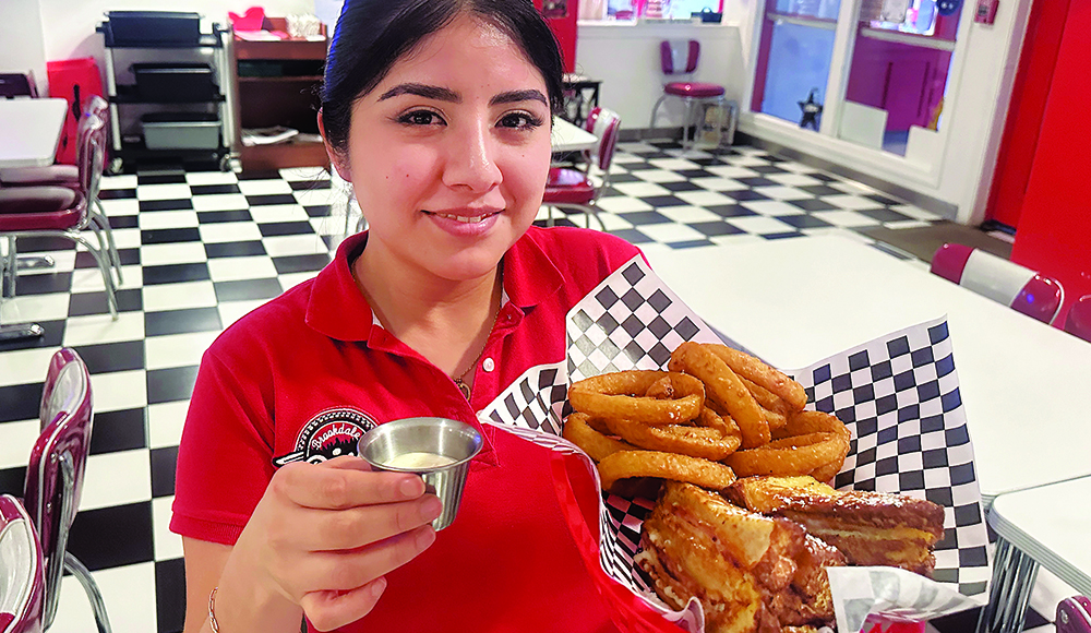 Sherlyn Alvarez serves the Monte Carlo sandwich with onion rings at Brookdale Diner