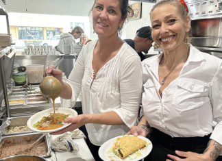 Fire-Ravaged El Toro Bravo Opens Staff members serve food in the kitchen at El Toro Bravo following the restaurant’s reopening.