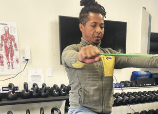 Not Just a Gym Trainer Guy Ferreira demonstrates resistance band exercises at Santa Cruz Core Fitness