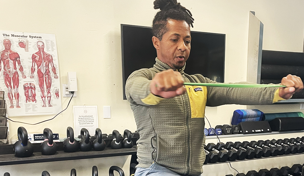 Trainer Guy Ferreira demonstrates resistance band exercises at Santa Cruz Core Fitness