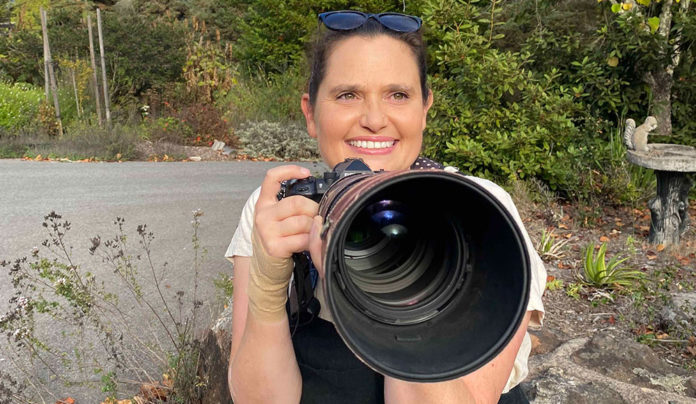 Local Photographer Captures International Attention Photographer Rebecca E. Hall holding a camera outdoors in Santa Cruz County