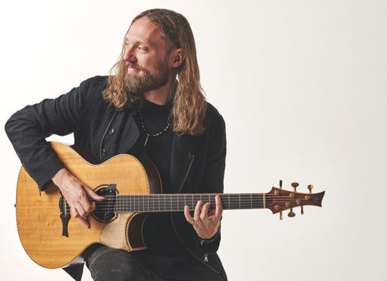 Things to do in Santa Cruz Guitarist Mike Dawes holding an acoustic guitar