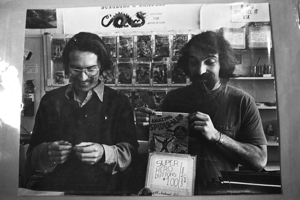 Jim Aschbacher and Joe Ferrara holding a copy of Spider-Man at Atlantis Fantasyworld in 1976