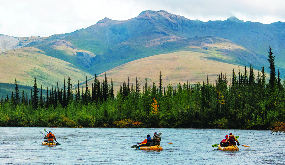 Kayakers paddle through a remote Alaskan river during Arctic Alchemy.