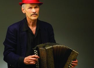 Ballistic New Music Jon Scoville performing with concertina during multimedia music performance