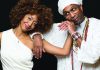 Darkness to Light Yilian Cañizares and Omar Sosa pose together in white attire in a studio portrait.