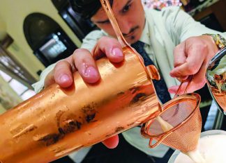 Mad Drip Bartender straining whiskey sour cocktail at Pearl bar in Santa Cruz