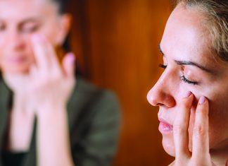 Tap, Tap, Tap Woman gently tapping her face in a stress relief technique known as Emotional Freedom Technique.