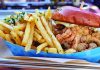 Airwave Crave Fried chicken sandwich on a brioche bun served with seasoned French fries in a paper tray