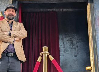 Slam Dunk Max Turgliatto stands at the entrance of Alley Oop in downtown Santa Cruz before its opening in Cedar Square.