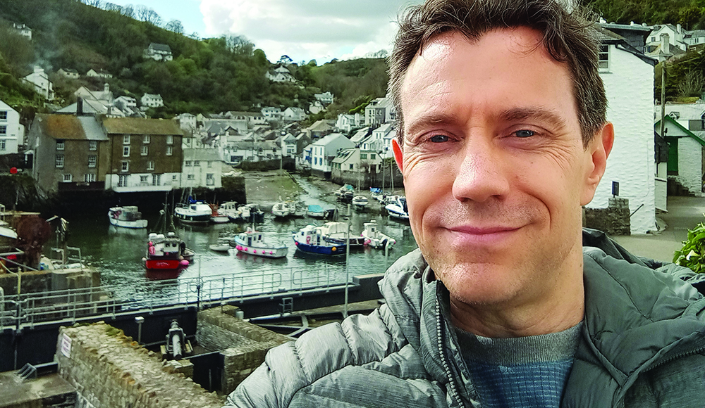 Artist Rich Karat Hitchcock stands above the harbor in Polperro, Cornwall, England.