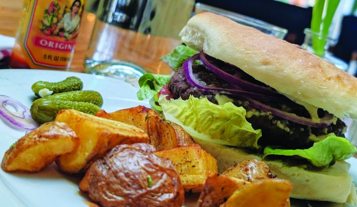 Bun Voyage Grassfed beef burger with aioli and Swank Farms lettuce and tomato at Gabriella Cafรฉ in Santa Cruz.