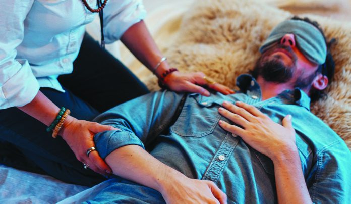 Mindful Psychedelics Therapist guides a blindfolded patient during a psychedelic-assisted therapy session at SoulCare Studios.