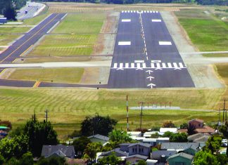 Housing Too Close to Runway Runway at Watsonville Municipal Airport with nearby residential neighborhood in the foreground.