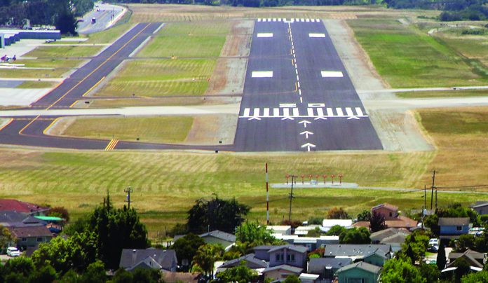 Housing Too Close to Runway Runway at Watsonville Municipal Airport with nearby residential neighborhood in the foreground.