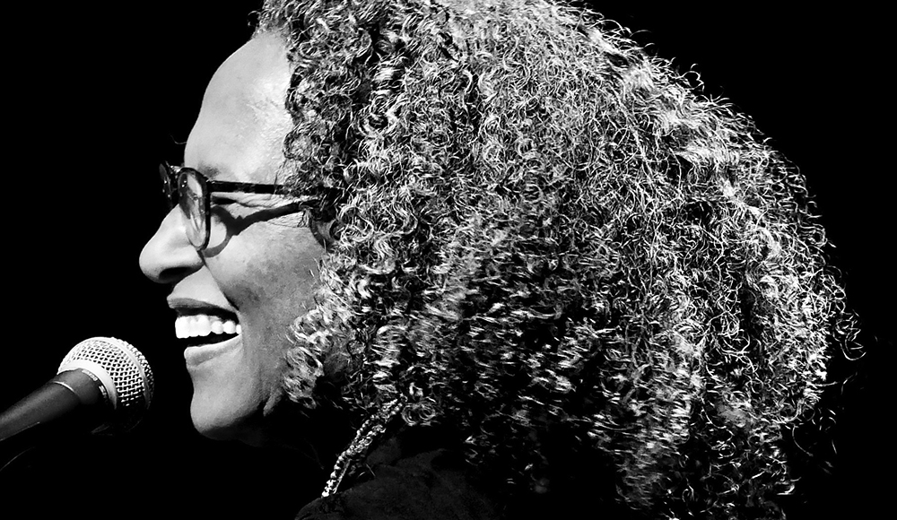 Vicki Randle performing on stage with microphone