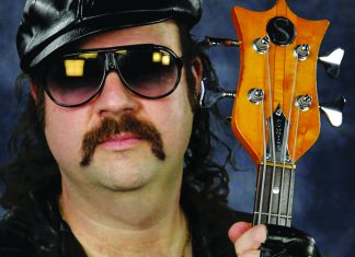 Things to do in Santa Cruz Donny Benét wearing sunglasses and holding a bass guitar